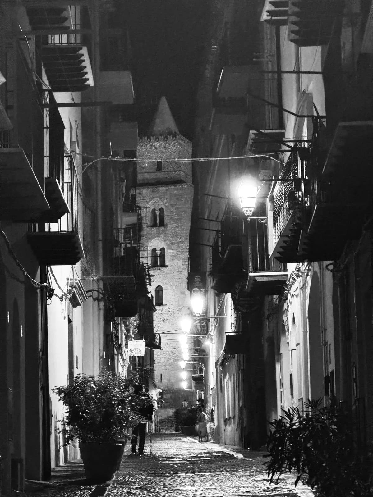 Lit shrine in an alley at night in Cefalù old town